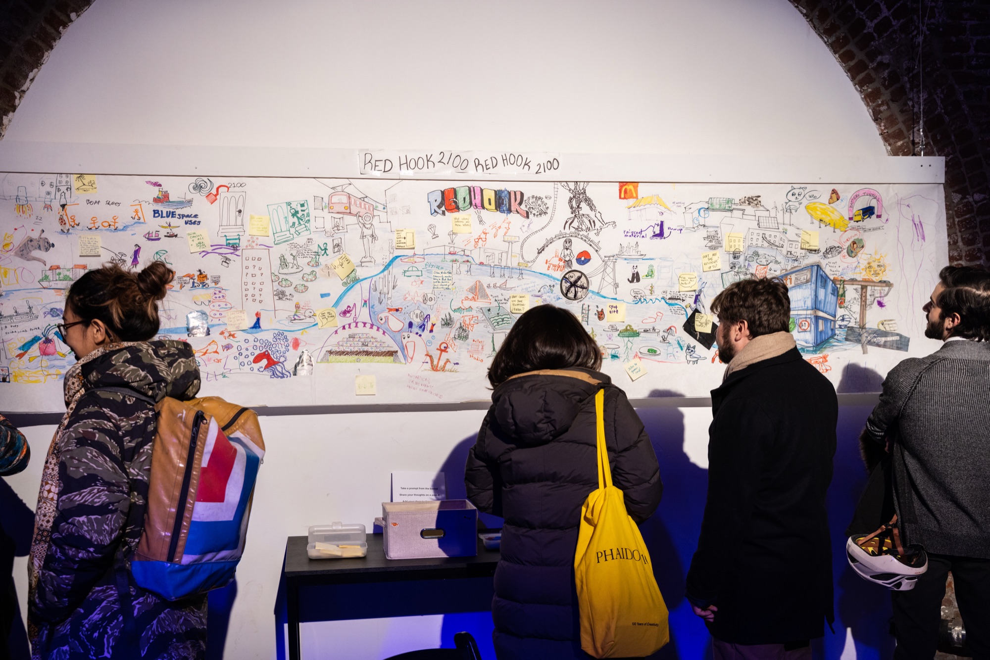 Attendees adding drawings to a collaborative Red Hook 2100 mural imagining the neighborhood's climate future
